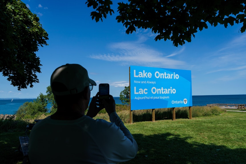A billboard saying 'Lake Ontario, Now and Always' in both English and French.
