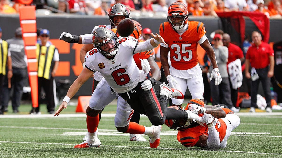 Baker Mayfield fumbles the football during a game at Paycor Stadium.