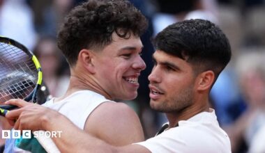 Ben Shelton and Carlos Alcaraz hug after their 2025 French Open match