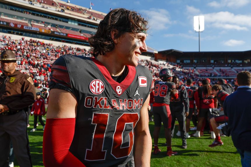 Oklahoma quarterback John Mateer (10) walks across the field after his team defeated Missouri in an NCAA college football game in Norman, Oklahoma, on November 22, 2025.