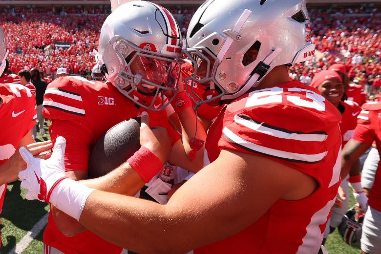 Julian Sayin #10 of the Ohio State Buckeyes celebrates a 14-7 win over the Texas Longhorns with Garrett Stover #23 at Ohio Stadium, in Columbus, Ohio, on August 30, 2025.
