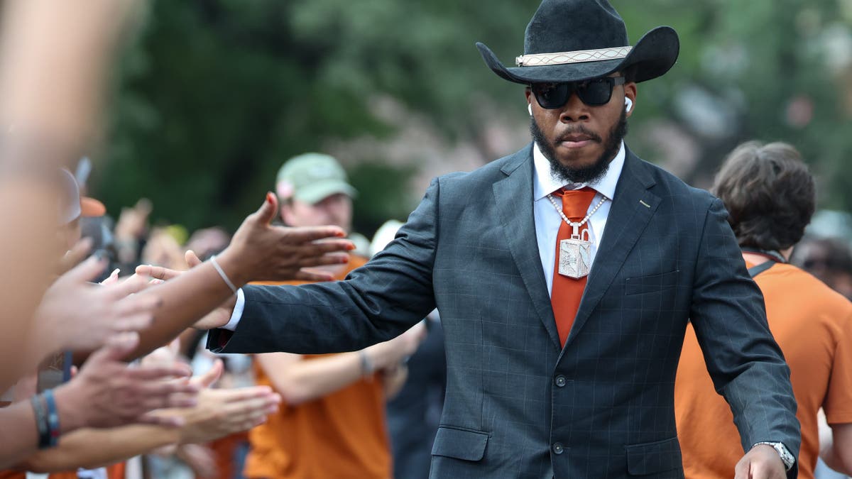 Colin Simmons high-fives fans while walking into the stadium in Austin, Texas.