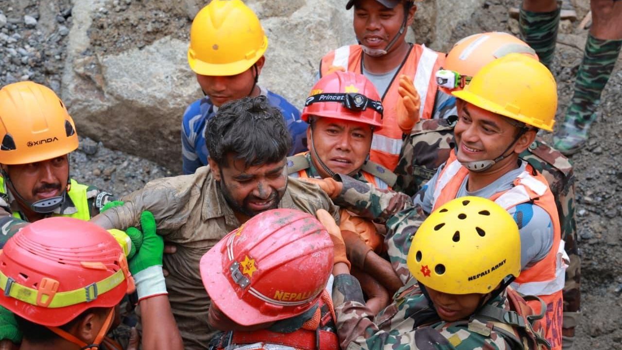 Photos from the Nepali army show rescuers crawling through mud and survivors on stretchers being pulled from a cave nine days after a devastating flash flood in the country.