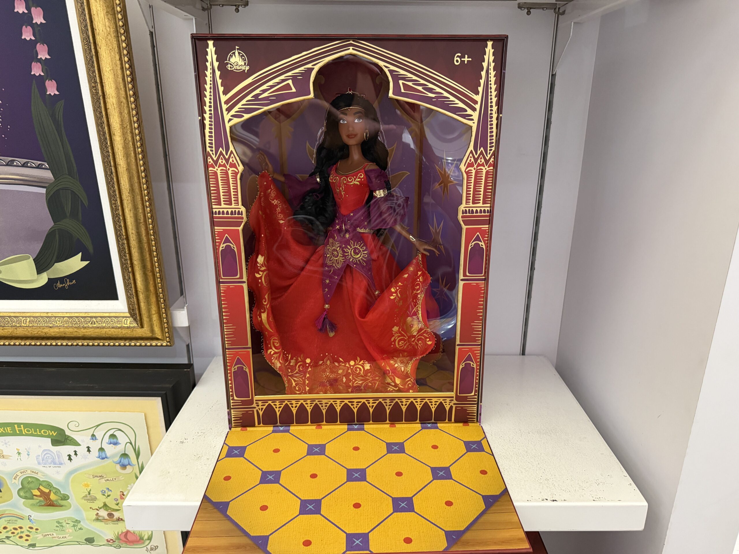 Esmeralda stands 16 inches tall and wears her stunning dress from The Feast of Fools at the beginning of the film, where she is first spotted by Quasimodo giving a Gypsy performance before all of Paris.
A stand is included with the doll. The box is designed to be a proper collectable display that mimics Esmeralda's Feast performance stage. The flat opens and closes magnetically.
A stand is included with the doll. The box is designed to be a proper collectable display that mimics Esmeralda's Feast performance stage. The flat opens and closes magnetically.