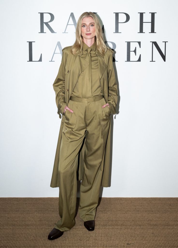 Elizabeth Debicki in a monochrome olive green suit and trench coat at the Ralph Lauren Spring 2027 Runway Show.