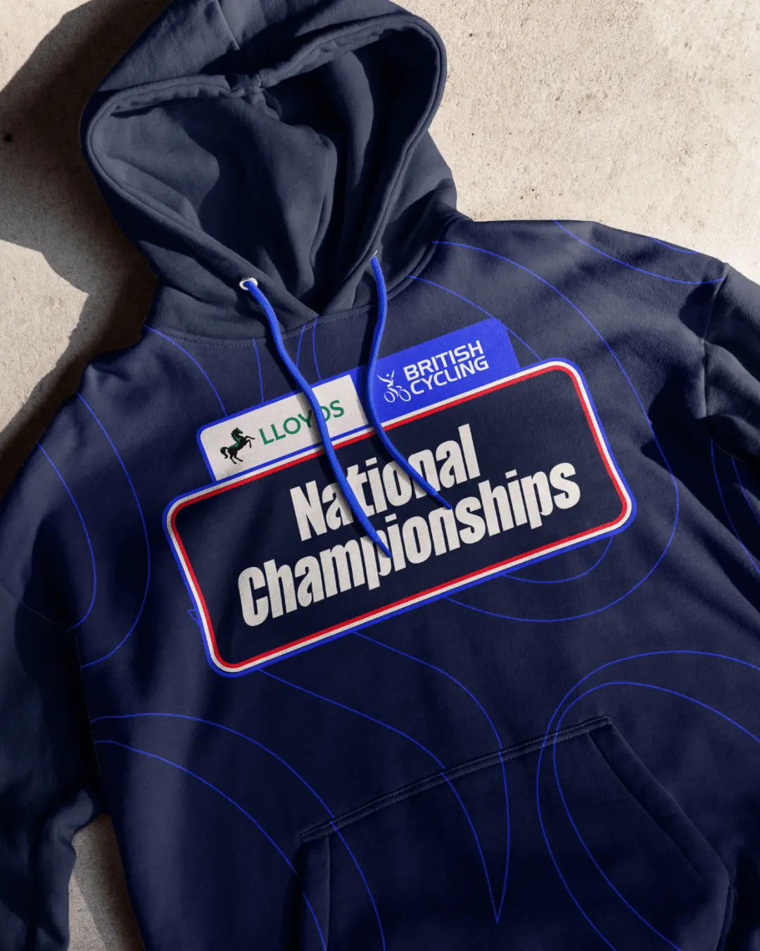 Navy hooded sweatshirt featuring British Cycling and Lloyds National Championships branding with blue stitching detail