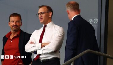 Daniel Kretinsky (centre) with is arms crossed
