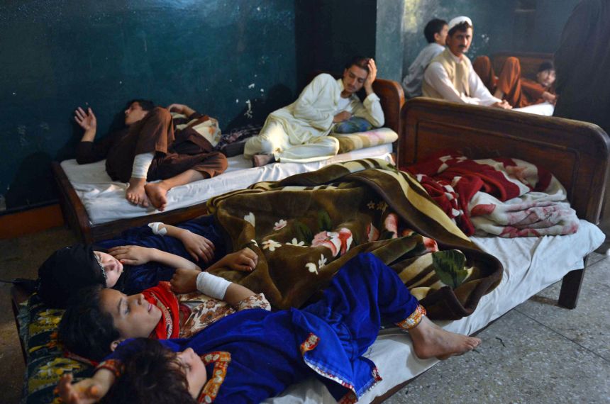 Pakistani victims of a US drone attack rest on a bed after they arrived in Peshawar on November 3, 2012.