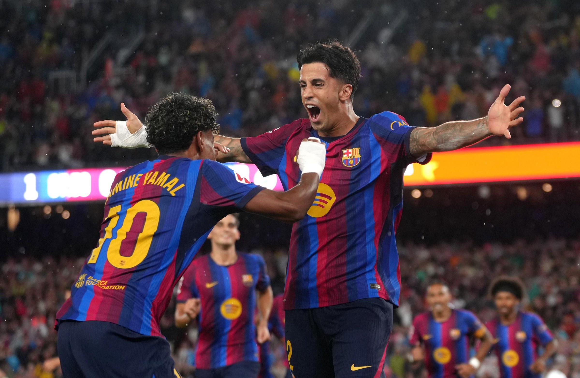 BARCELONA, SPAIN - SEPTEMBER 16: Joao Cancelo of FC Barcelona celebrates scoring his team’s first goal with teammate Lamine Yamal during the LaLiga EA Sports 2026/27 match between FC Barcelona and Real Racing Club de Santander at Spotify Camp Nou on September 16, 2026 in Barcelona, Spain. (Photo by Alex Caparros/Getty Images)