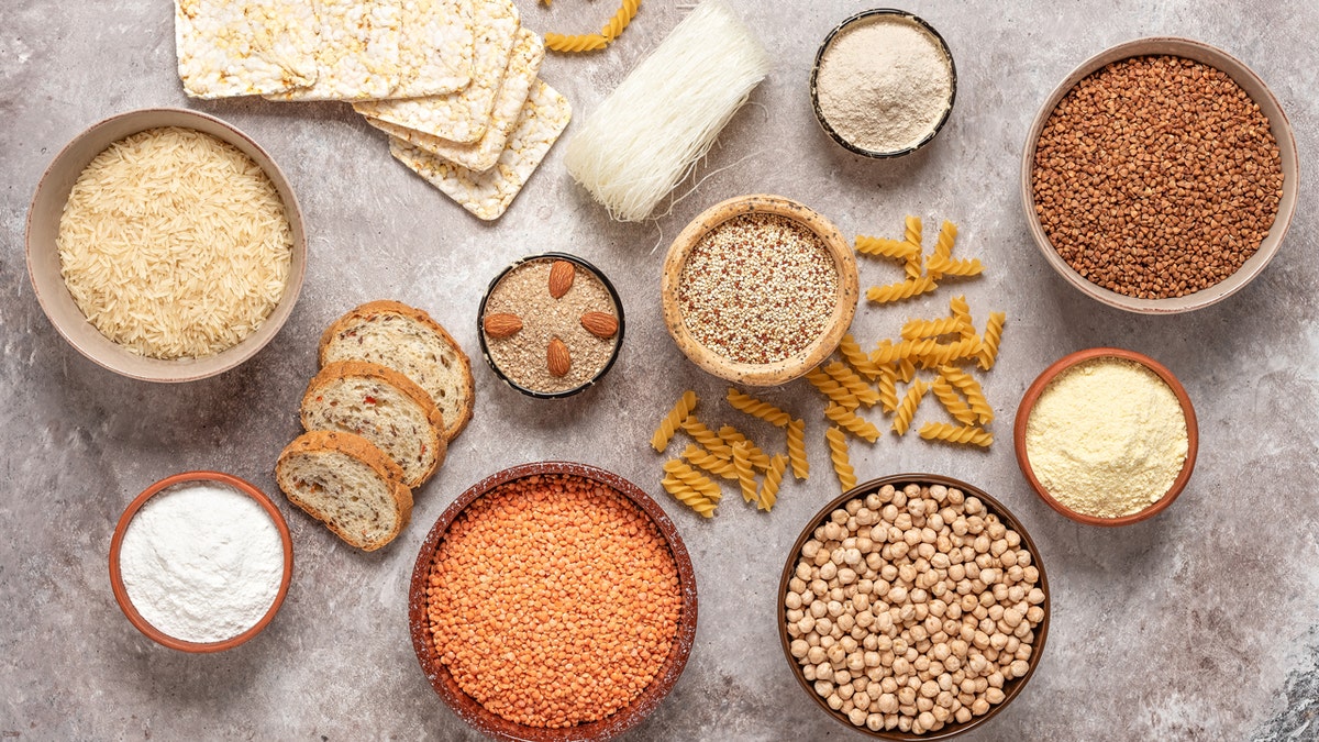 A variety of gluten-free grains, flours, pasta and bread as seen from above.