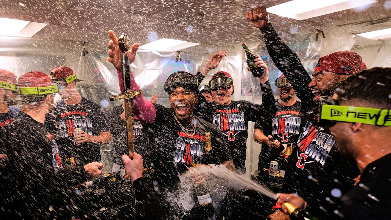 Cleveland Guardians' Angel Martínez, center, celebrates with teammates after clinching a postseason playoff spot following a baseball game against the Boston Red Sox, Thursday, Sept. 24, 2026, in Boston. (AP Photo/Charles Krupa)