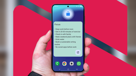 Hand holding a smartphone displaying a 'Focus' widget with a list of daily goals on the home screen.