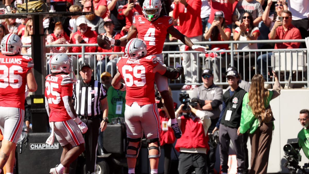 Jeremiah Smith celebrates a touchdown with Ian Moore during a college football game at Ohio Stadium.