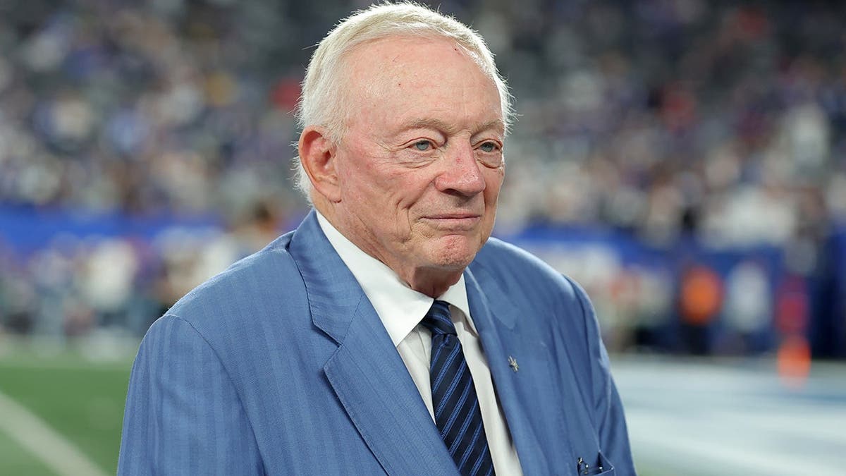 Jerry Jones stands on the field at MetLife Stadium before a Cowboys-Giants game.