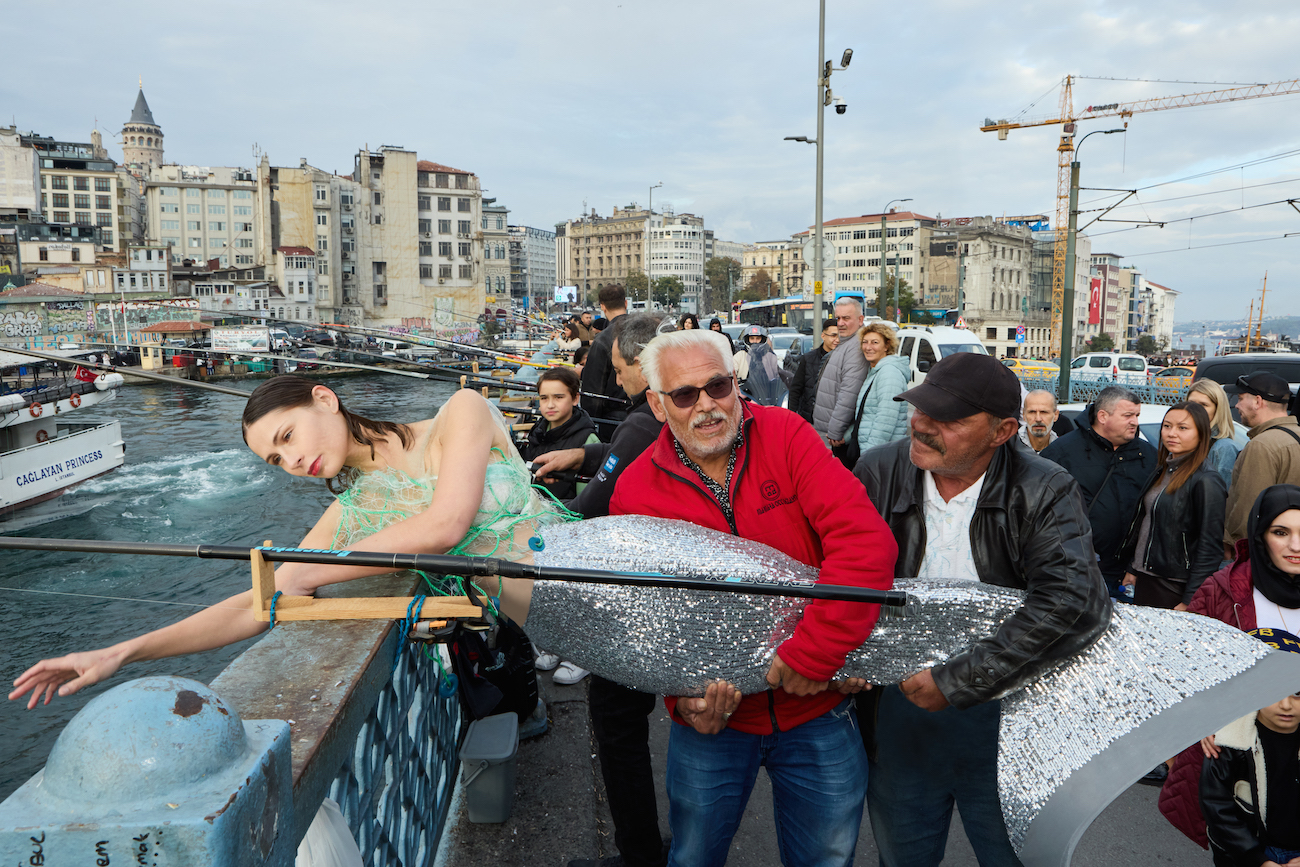 Photo of people holding woman dress in mermaid costume on boat taken by Julia Buruleva