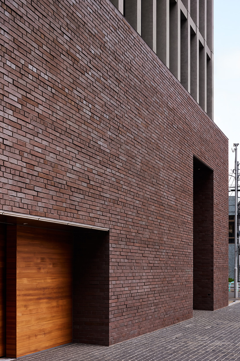 KIAS pairs textured brick facade with planted atrium for headquarters in japan - 3