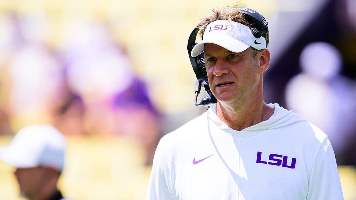 Lane Kiffin stands during LSU fall practice at Tiger Stadium.