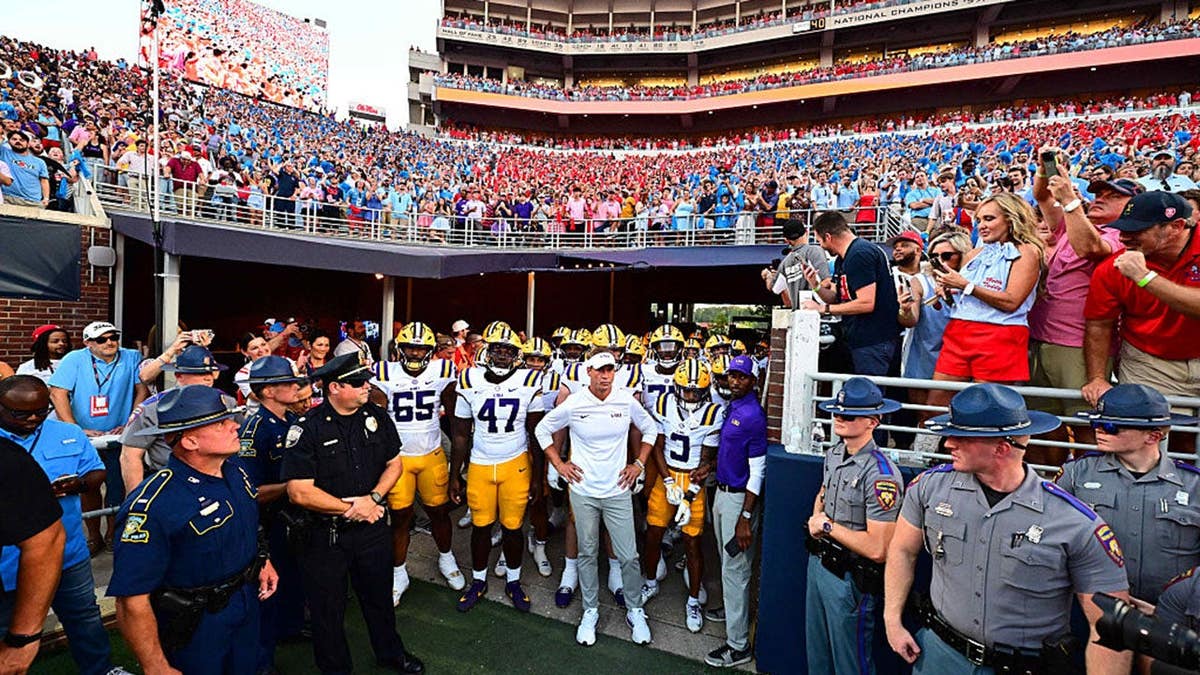 Lane Kiffin stands on the field at Vaught Hemingway Stadium in Oxford, Miss.