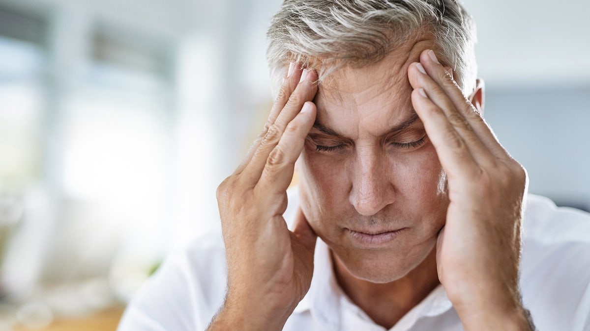 Man holding head