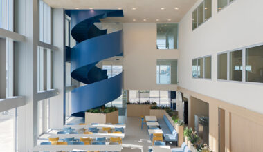blue spiral staircase anchors ERRE’s harbor-side workspace in valencia