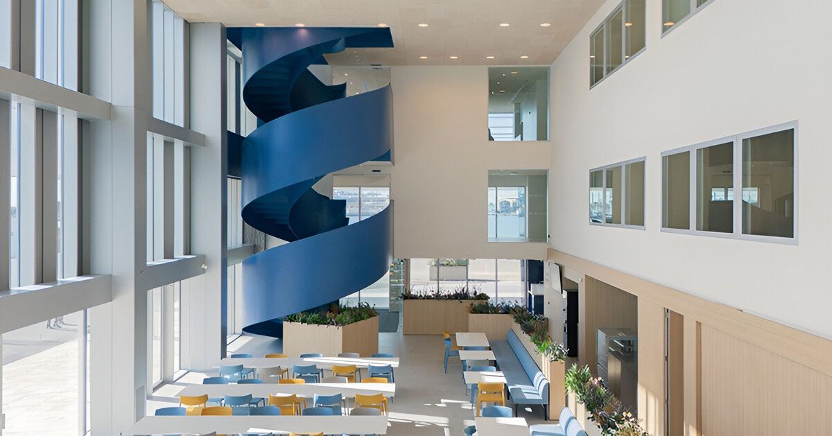blue spiral staircase anchors ERRE’s harbor-side workspace in valencia