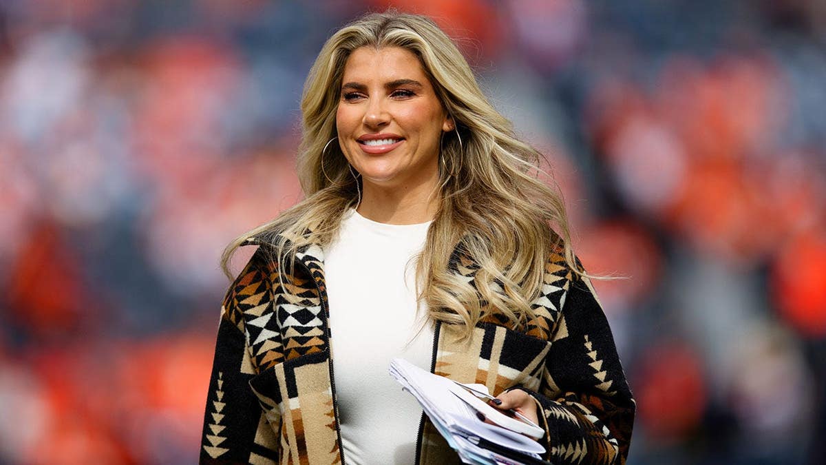 Melanie Collins walks on the field before a Denver Broncos game at Empower Field at Mile High.