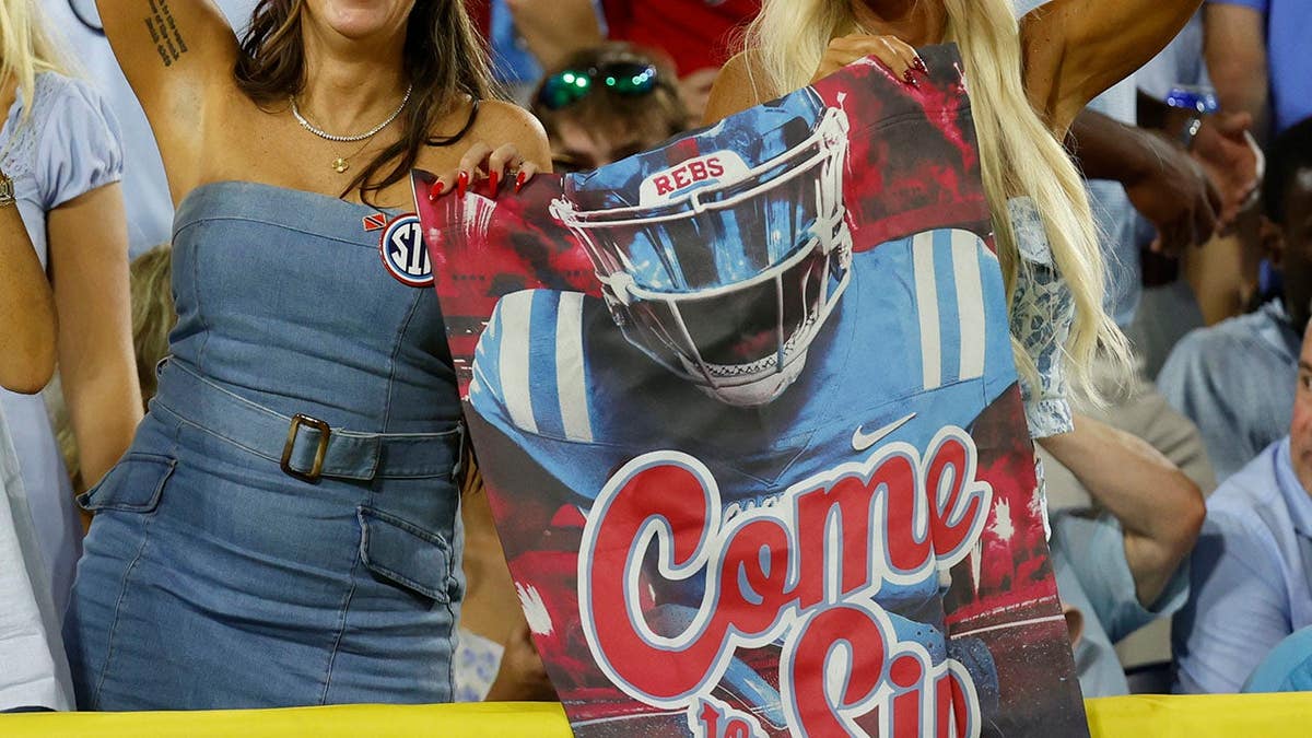 Mississippi Rebels fans cheer in the stands at Nissan Stadium.