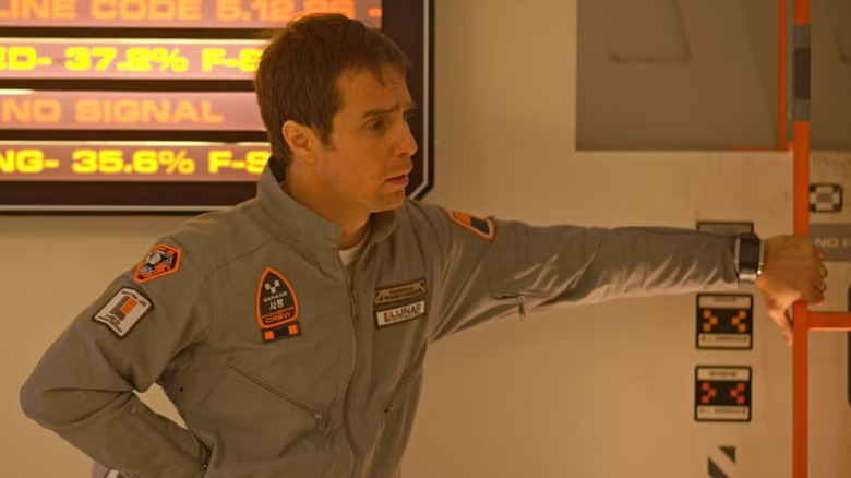 Sam Bell leaning against a wall in Moon