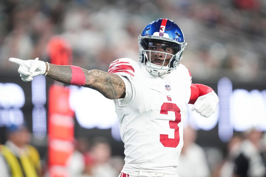 Odell Beckham Jr. in a white jersey and blue helmet pointing during a game.