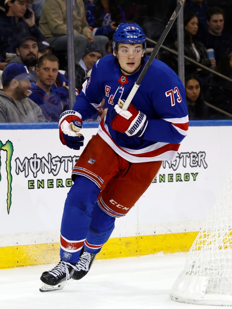 New York Rangers forward Matt Rempe skates on the ice.