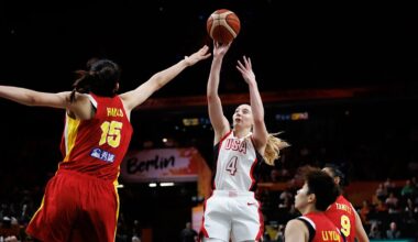 United States guard Paige Bueckers, No. 4, releases a jump shot as China center Han Xu contests with both arms raised.