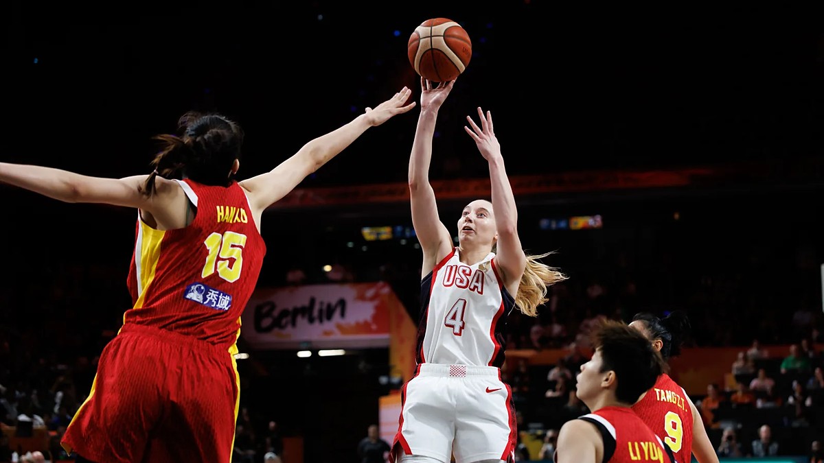 United States guard Paige Bueckers, No. 4, releases a jump shot as China center Han Xu contests with both arms raised.