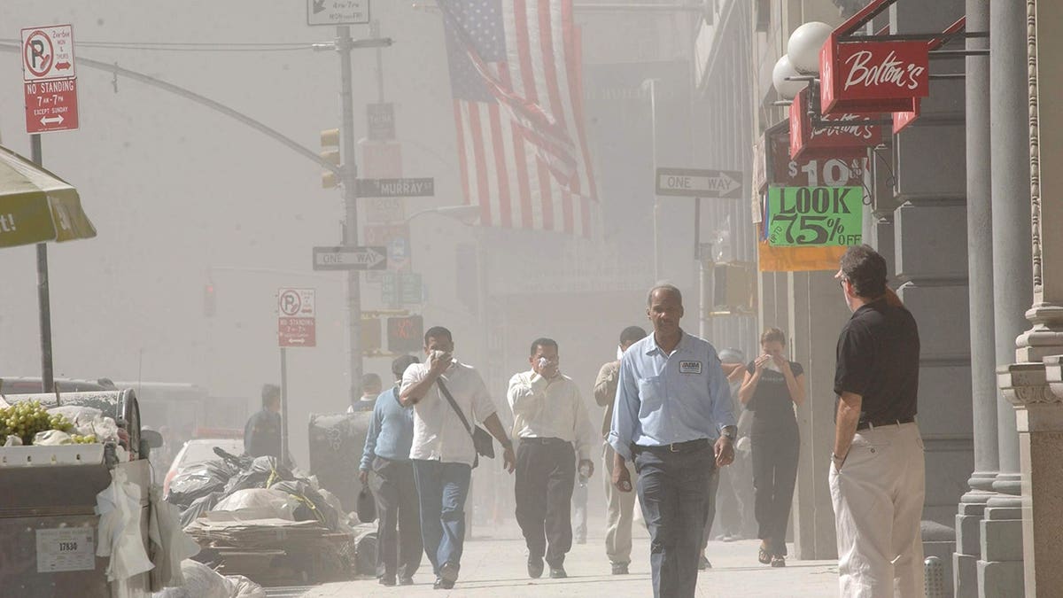 People rush away from the collapsing World Trade Center in New York City.