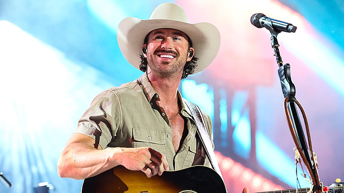Riley Green plays guitar at CMA Fest 2025