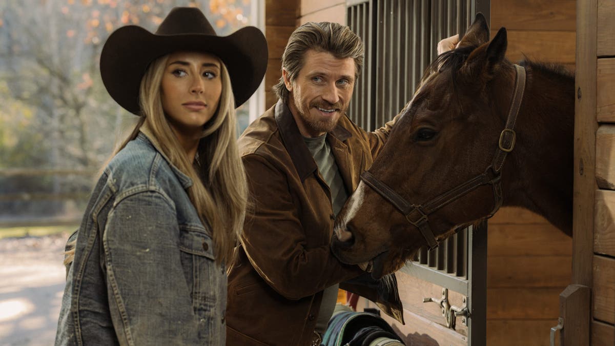 Scarlet Stallone as Spencer and Garrett Hedlund as Mitch stand together in a scene from Tulsa King.