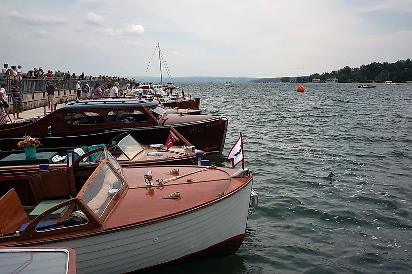 Restored wooden boats and crowds at the Antique and Classic Boat Show in Skaneateles, New York.