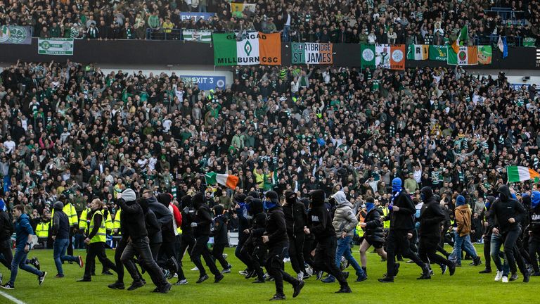 Police clash with fans after they stormed the pitch during last season's Scottish Cup quarter-final