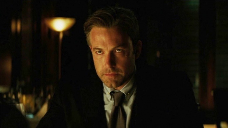 Bruce Wayne (Ben Affleck) stands in a dark room tensely in Suicide Squad
