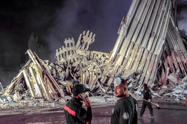 FILE - First responders work at ground zero after the Sept.11 attacks, Sept. 12, 2001, in New York. Americans are looking back on the horror and legacy of 9/11, gathering Monday, Sept. 11, 2023, at memorials, firehouses, city halls and elsewhere to observe the 22nd anniversary of the deadliest terror attack on U.S. soil. (AP Photo/Suzanne Plunkett, File)