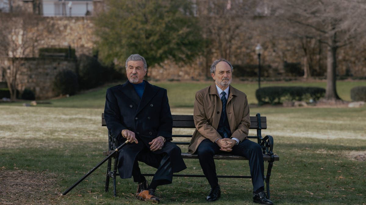 Sylvester Stallone as Dwight Manfredi and Kevin Pollak as Special Agent Musso stand together in a scene from Tulsa King.