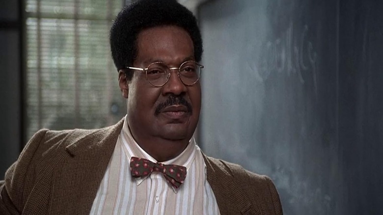 Eddie Murphy as Sherman Klump standing next to a chalkboard in The Nutty Professor