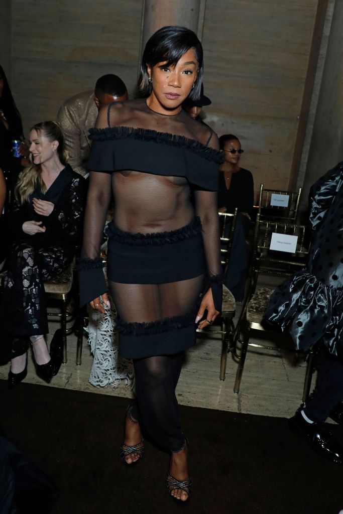 Tiffany Haddish wearing a sheer black outfit at the Christian Siriano show during New York Fashion Week.