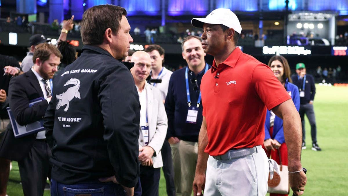 Tiger Woods speaks with Gov. Ron DeSantis before a TGL match in Palm Beach Gardens, Florida.