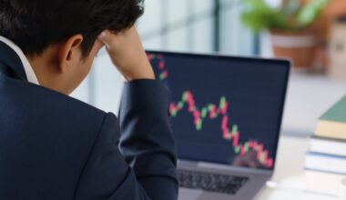 Person with hand on head looking at a chart of a stock price crashing.