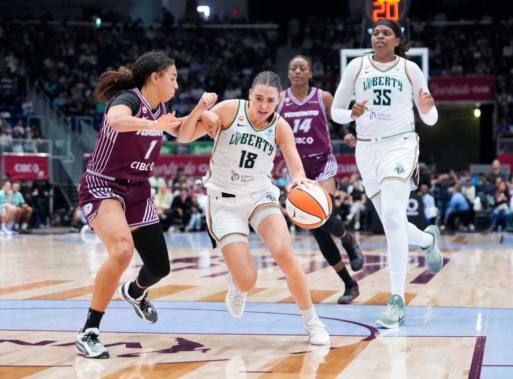 Pauline Astier of the New York Liberty drives the basketball past Kiki Rice of the Toronto Tempo.