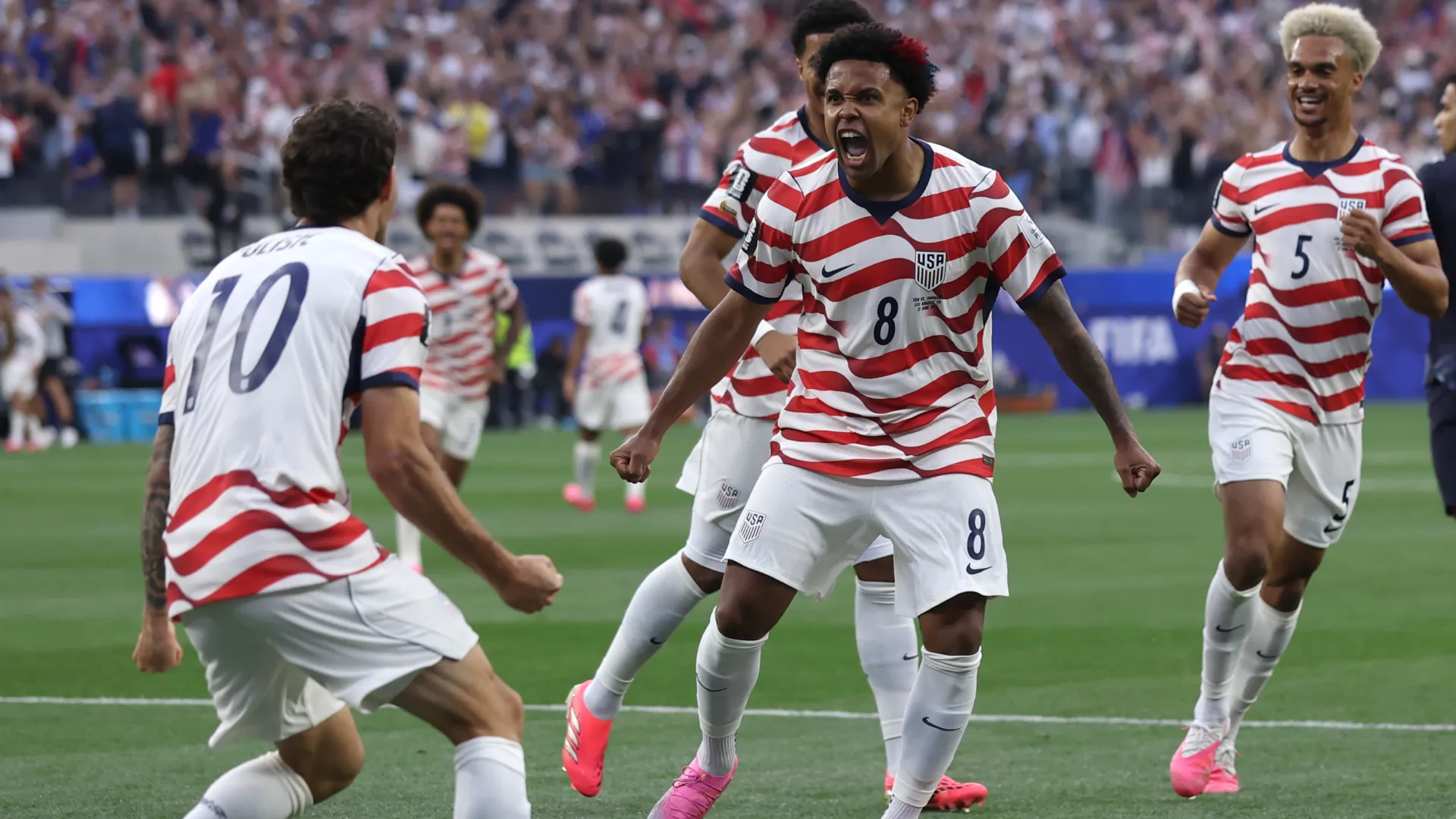 Christian Pulisic #10 and Weston McKennie #8 of the United States celebrate a goal.