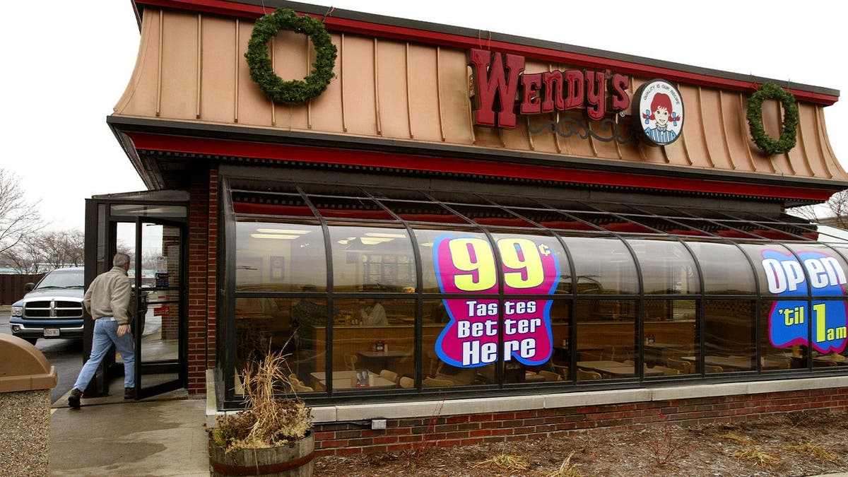 The exterior of a Wendy's restaurant with a sunroom.
