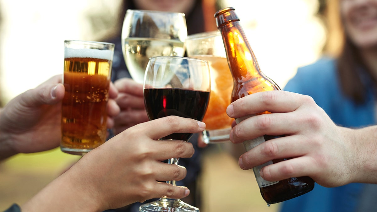 Friends clinking drinks together