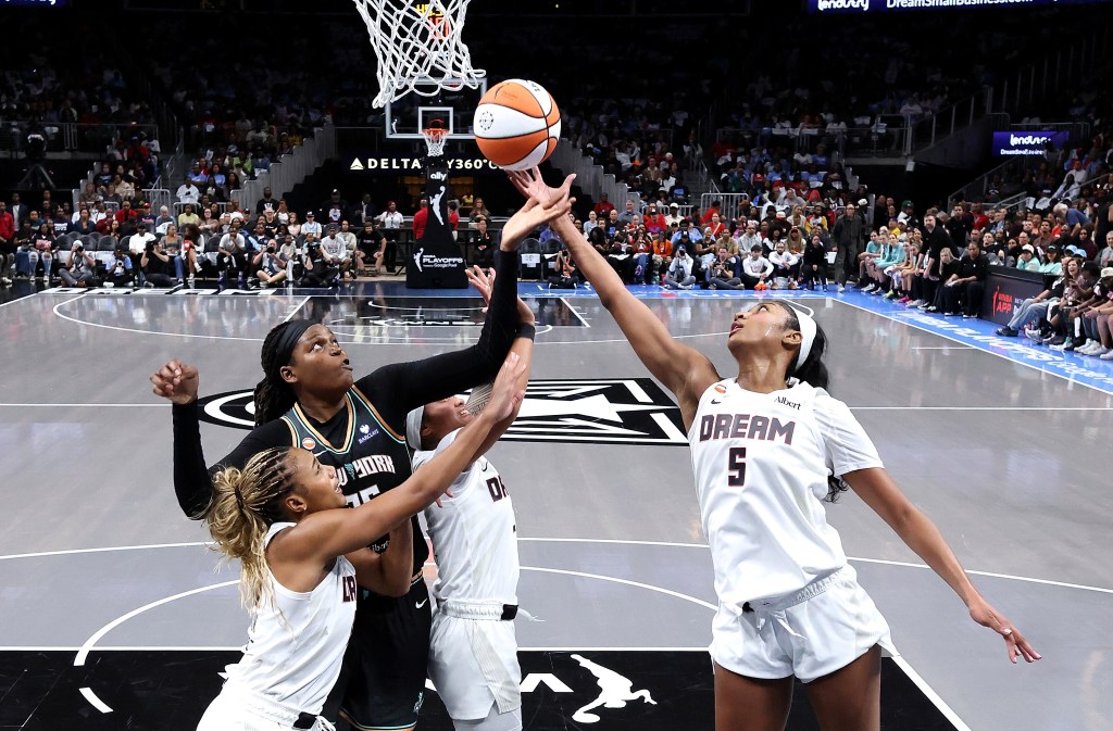 Angel Reese, Naz Hillmon, and Te-Hina Paopao of the Atlanta Dream battle for a rebound against Jonquel Jones of the New York Liberty during the WNBA playoffs.