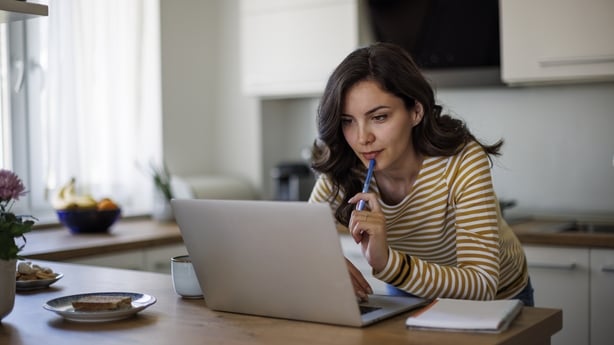 Young woman using a laptop while working from home